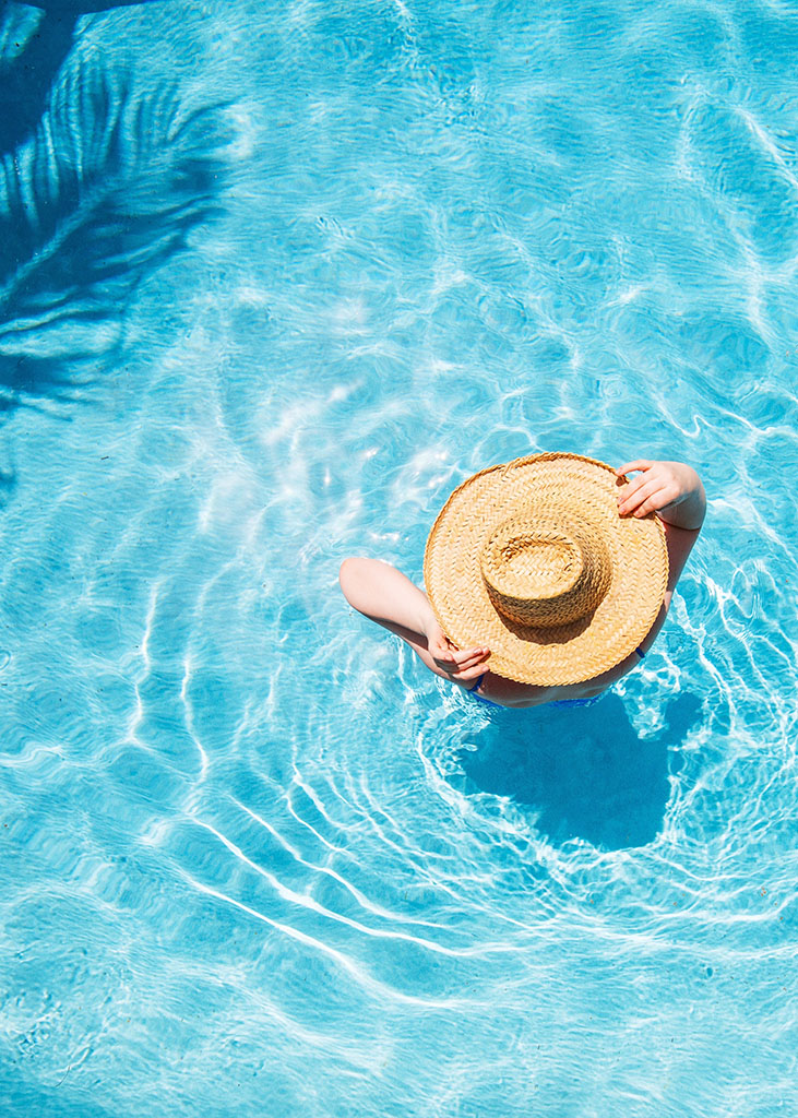 Top,View,Of,Beautiful,Woman,Earing,Sunhat,Relaxing,In,Swimming